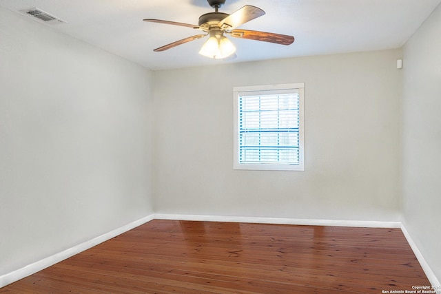 empty room featuring ceiling fan and hardwood / wood-style floors