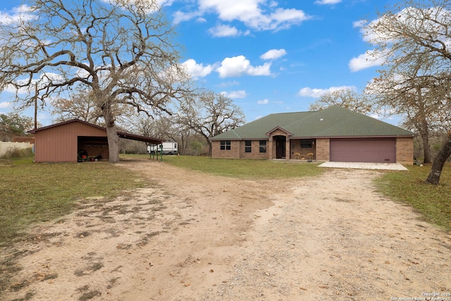 view of front facade with a front lawn, a carport, and a garage