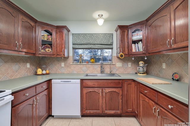 kitchen with tasteful backsplash, sink, light tile patterned flooring, and white appliances