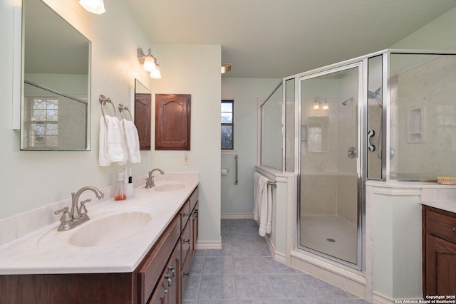 bathroom with tile patterned floors, vanity, and a shower with shower door