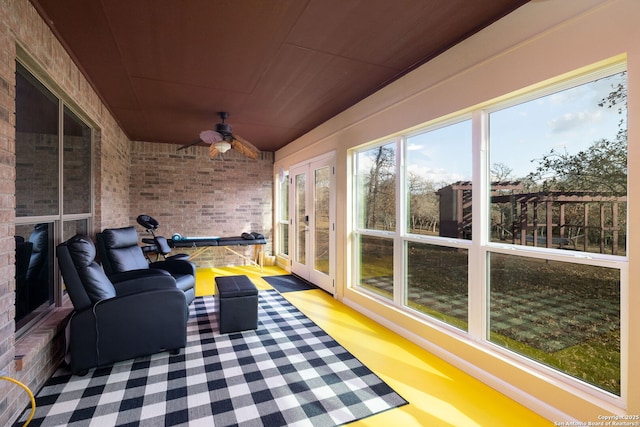 sunroom featuring ceiling fan and wooden ceiling