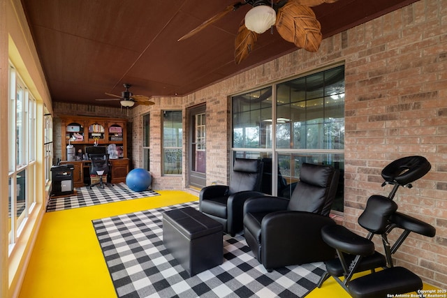 interior space with ceiling fan, a healthy amount of sunlight, and wooden ceiling