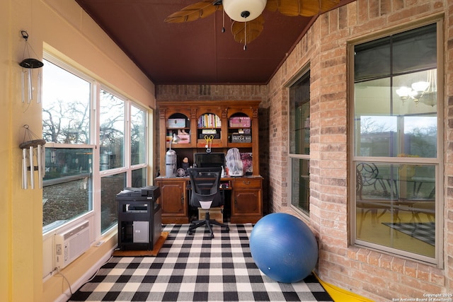 office featuring ceiling fan and brick wall