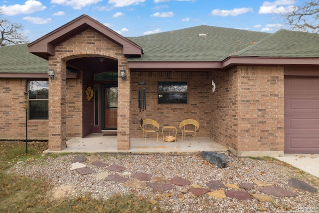 view of exterior entry featuring a garage