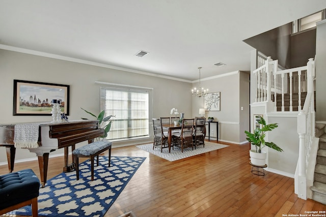 interior space with crown molding, hardwood / wood-style floors, and an inviting chandelier