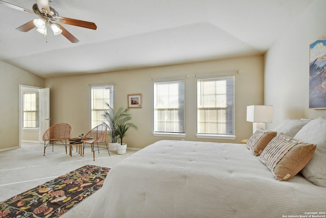 carpeted bedroom with vaulted ceiling and ceiling fan