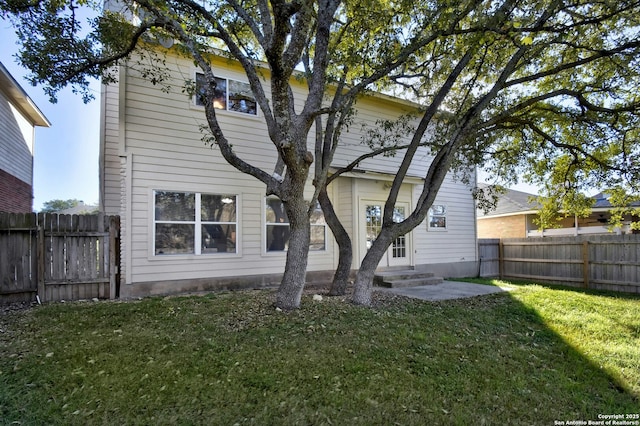 rear view of property with a yard