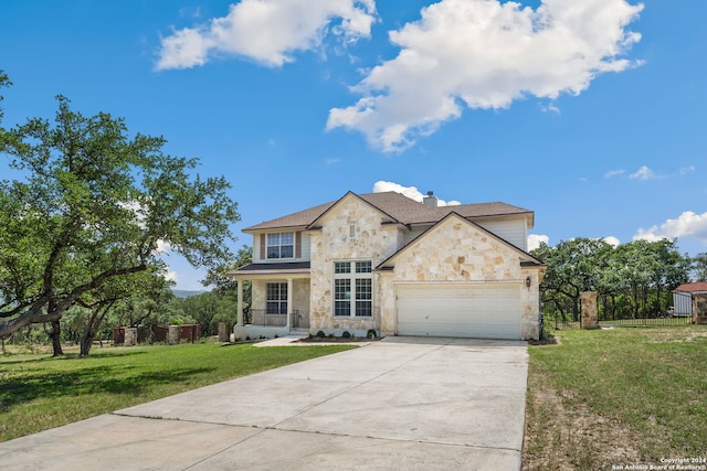 view of front of home with a garage and a front lawn