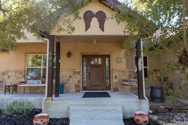 view of exterior entry featuring a porch