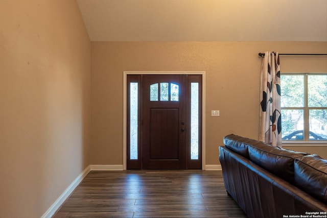 foyer with dark hardwood / wood-style floors and lofted ceiling