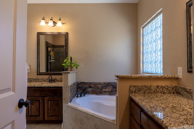 bathroom featuring tile patterned floors, vanity, plenty of natural light, and shower with separate bathtub