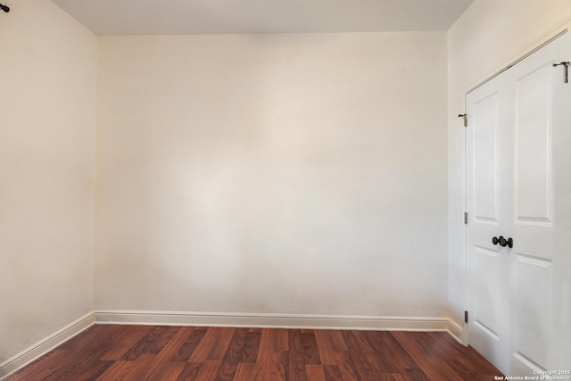 unfurnished room with dark hardwood / wood-style floors