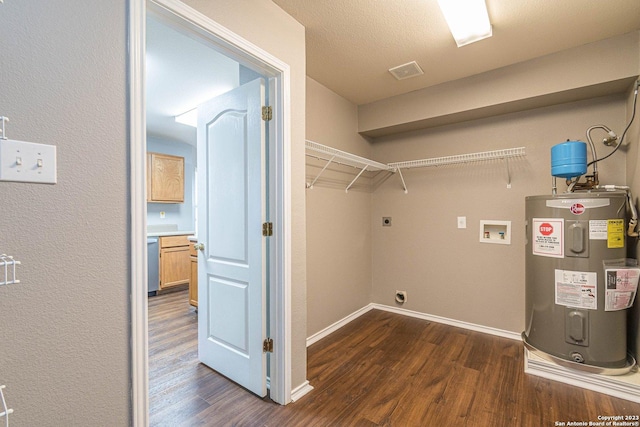 laundry room with dark wood-type flooring, water heater, hookup for an electric dryer, and washer hookup