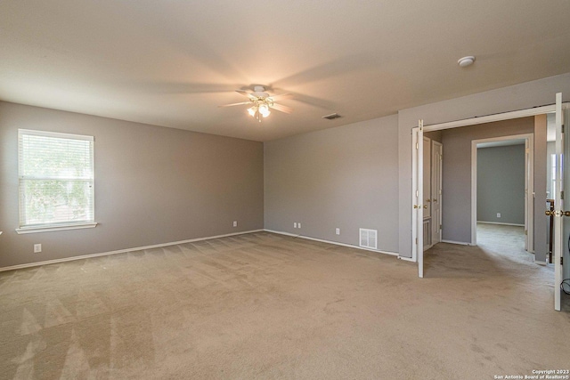 carpeted empty room with ceiling fan