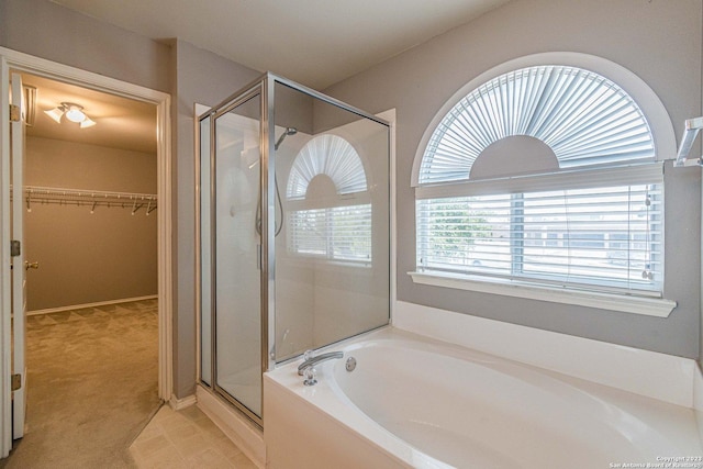 bathroom featuring separate shower and tub