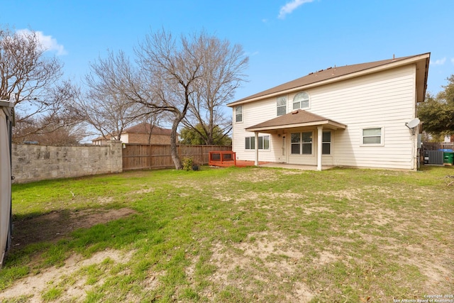 back of house featuring central AC, a patio area, and a lawn