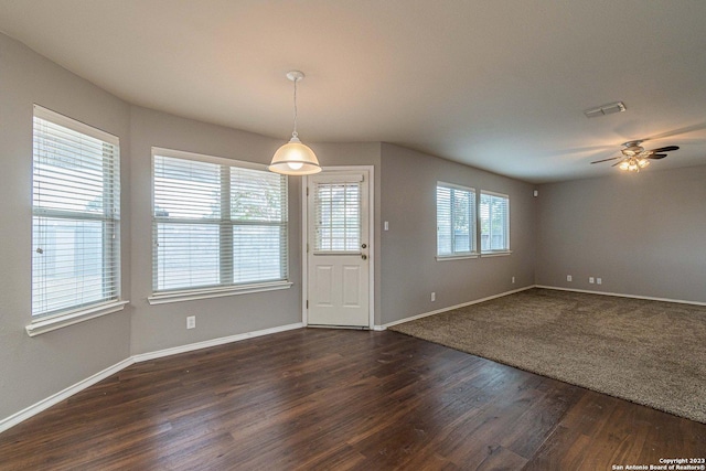 interior space with ceiling fan and dark hardwood / wood-style flooring