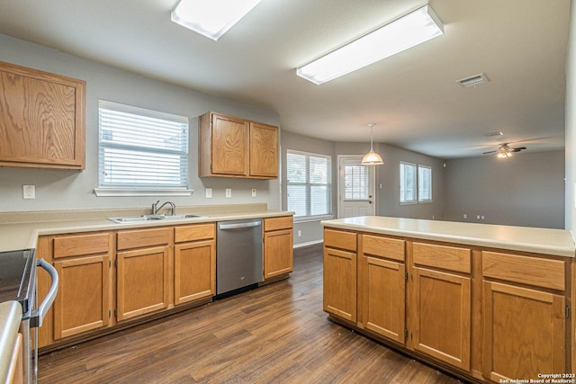 kitchen with appliances with stainless steel finishes, ceiling fan, pendant lighting, sink, and dark hardwood / wood-style floors