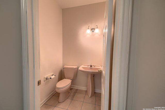 bathroom featuring tile patterned floors, toilet, and sink