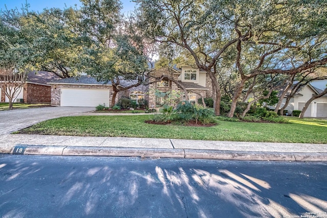 view of front of property featuring a front yard and a garage