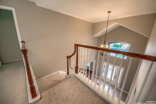 staircase with crown molding and a notable chandelier