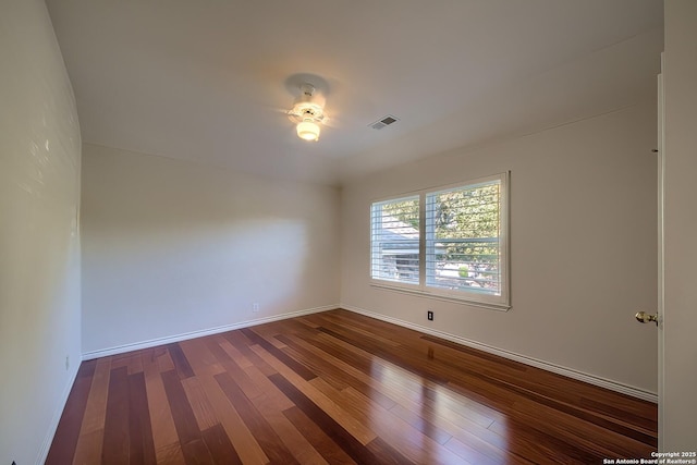 empty room with dark hardwood / wood-style floors