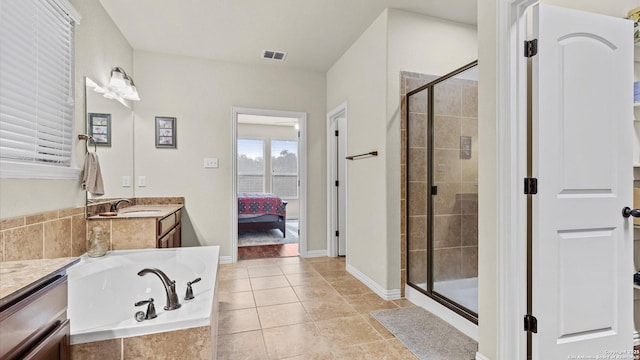 bathroom featuring tile patterned floors, vanity, and separate shower and tub