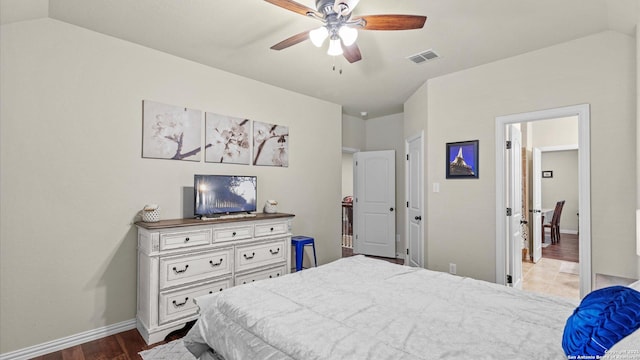 bedroom featuring wood-type flooring, vaulted ceiling, and ceiling fan