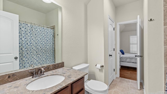 bathroom with tile patterned floors, vanity, and toilet