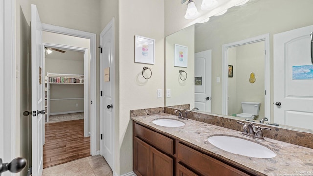 bathroom with tile patterned floors, vanity, and toilet