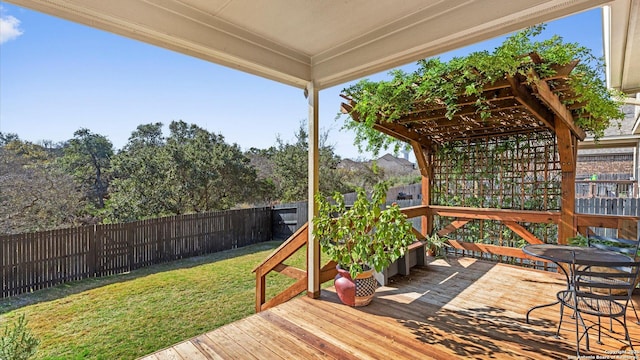 wooden deck with a yard and a pergola