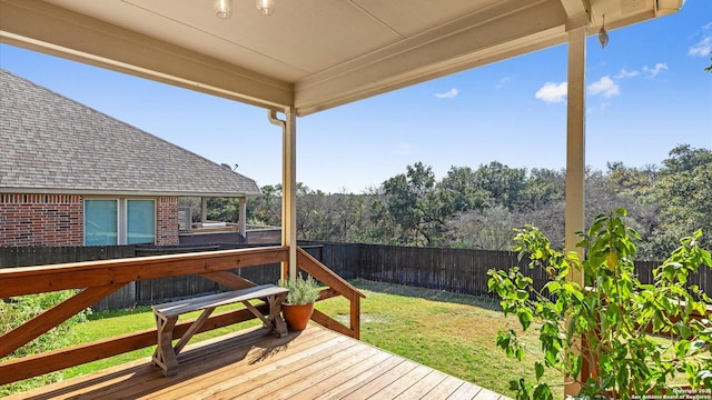 wooden deck featuring a yard