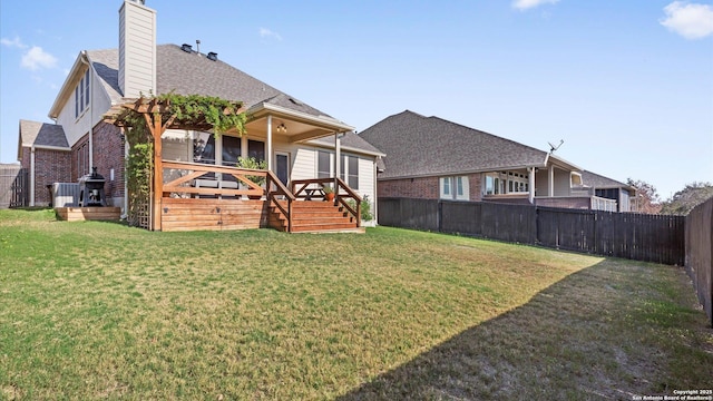 back of house with a lawn and a wooden deck