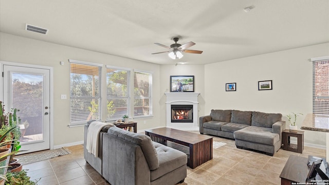 tiled living room with ceiling fan