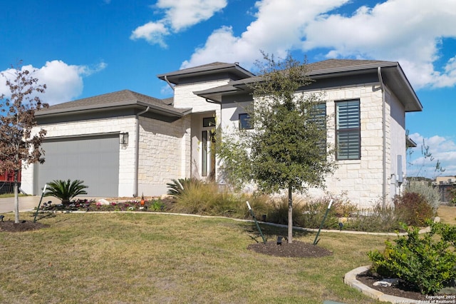 prairie-style house featuring a front yard and a garage