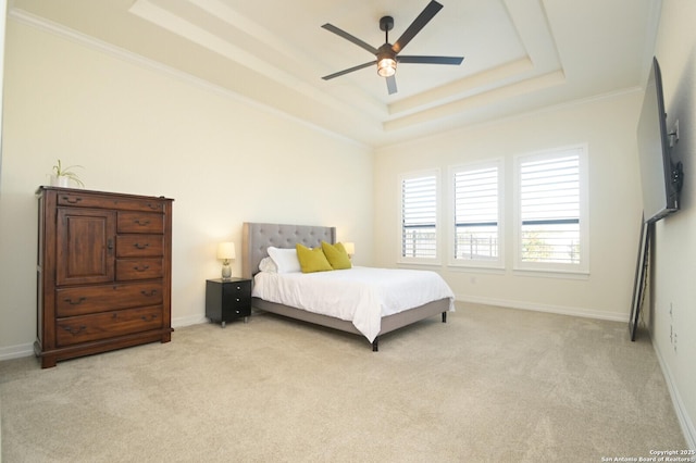 bedroom featuring a raised ceiling, ceiling fan, crown molding, and light colored carpet