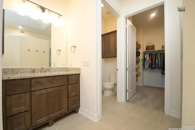 bathroom with tile patterned flooring, vanity, and toilet