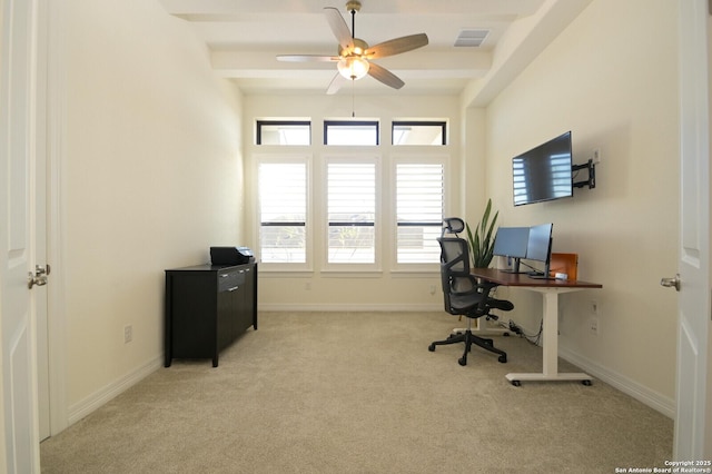 carpeted home office featuring ceiling fan