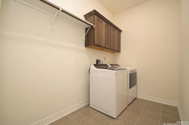 laundry area featuring tile patterned flooring, cabinets, and independent washer and dryer