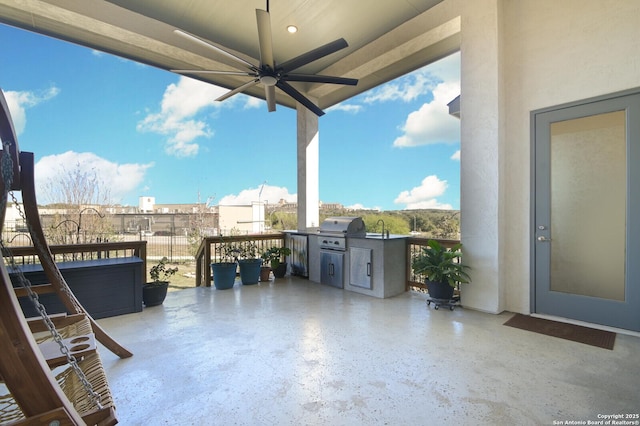 view of patio featuring ceiling fan, sink, and grilling area