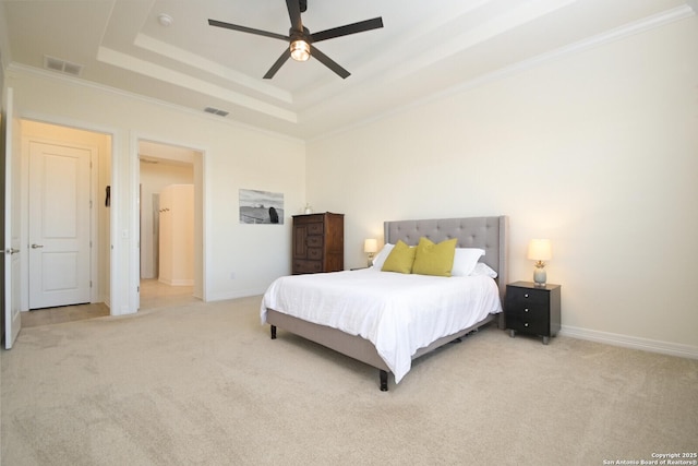 carpeted bedroom with a raised ceiling, ceiling fan, and ornamental molding