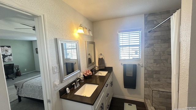 bathroom featuring a shower with shower curtain, plenty of natural light, ceiling fan, and vanity