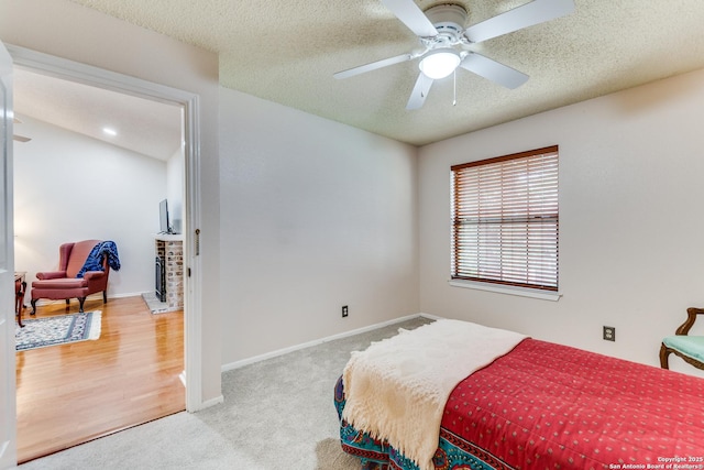 bedroom with carpet flooring, a ceiling fan, a textured ceiling, and baseboards