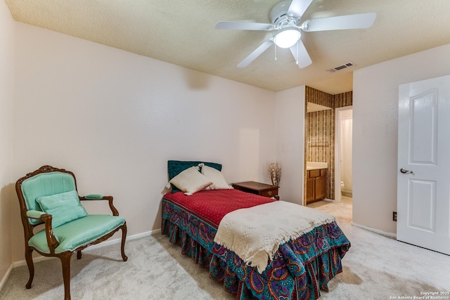 bedroom with ceiling fan, light colored carpet, a textured ceiling, baseboards, and visible vents