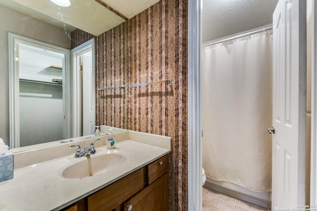 bathroom featuring a shower with curtain, a textured ceiling, tile patterned floors, vanity, and toilet