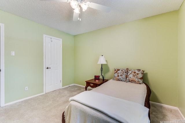 bedroom featuring carpet floors, a textured ceiling, and baseboards