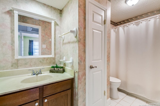 full bathroom featuring tile patterned flooring, a textured ceiling, toilet, and vanity