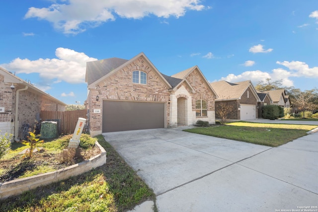 view of front of home with a front yard and a garage