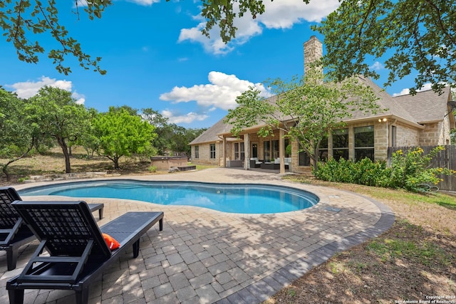 view of swimming pool featuring outdoor lounge area and a patio