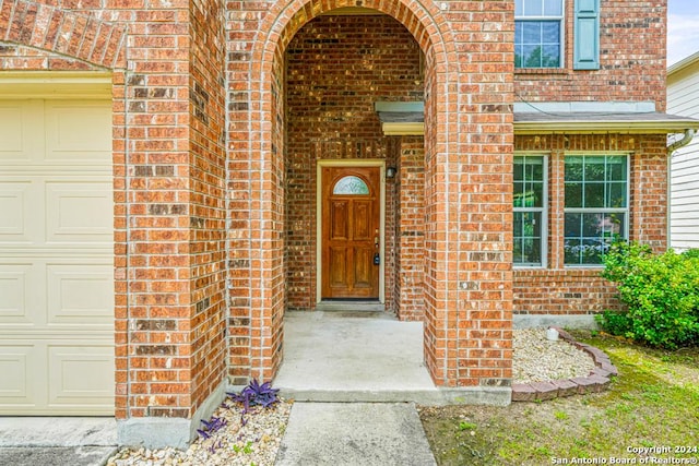 doorway to property with a garage